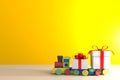 Christmas and New Year`s Day, Gift box with red ribbon and train on wood table Royalty Free Stock Photo