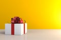 Christmas and New Year`s Day, Gift box with red ribbon on wood table, White gift box on yellow background with space Royalty Free Stock Photo