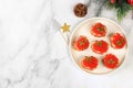 Christmas and New Year\'s dishes, a set of canapes for the festive table. Plate with tartlets of pate and red salmon caviar