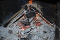 Christmas and New Year's fireplace, coals, firebrands and ash from burnt firewood. Royalty Free Stock Photo