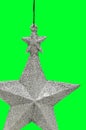 Christmas and New Year`s silver five-pointed star on green background. Retro toy Royalty Free Stock Photo