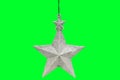 Christmas and New Year`s silver five-pointed star on green background. Retro toy Royalty Free Stock Photo