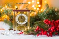 Christmas and New Year's still-life with a with a clock, red berries and spruce branches