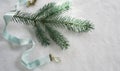 Christmas, new year. Satin blue ribbon and spruce twigs on a white background. top view