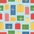 Christmas and New Year seamless pattern. Colorful gift boxes on blue background. Doodle style. Royalty Free Stock Photo