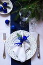 Christmas or New Year table decoration in white and blue colors. Royalty Free Stock Photo