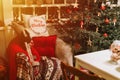 christmas and new year time. cozy soft armchair or easy chair with a comfy plaid and a red pad pillow Royalty Free Stock Photo