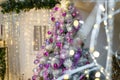 Christmas or New Year tree decorated with purple baubles, shiny star on top and garland lights with two white lanterns Royalty Free Stock Photo