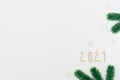 Christmas, New Year white background with fir tree branches, numbers 2021 and small white snowflakes. Xmas and Happy New Year Royalty Free Stock Photo