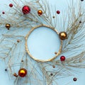 Christmas or new year winter composition. Round frame made of golden tree branches and red decorative Christmas ornaments on blue Royalty Free Stock Photo