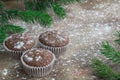 Three Christmas cakes on snowbound wooden background, fir tree b