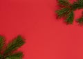 Christmas, New Year or winter red background with fir tree branches. Xmas and Happy New Year holiday concept. New Year greeting or Royalty Free Stock Photo