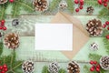 Christmas, new year,winter envelope mock up.Green wooden background with fir tree and pine cones. Flat lay Top view Royalty Free Stock Photo