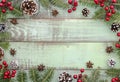 Christmas, new year,winter,Xmas frame green wooden background with fir tree, red berry and pine cones. Flat lay mock up Royalty Free Stock Photo