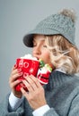 Christmas and New Year. Woman in knitted hat is drinking coffee. Royalty Free Stock Photo