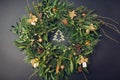 Christmas and New Year wreath made of fir, pine, mistletoe branches, cones decorated with golden ornaments Royalty Free Stock Photo