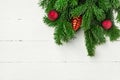 Christmas new Years background in retro vintage style with fresh fluffy fir tree branches red ornament balls on white plank wood Royalty Free Stock Photo