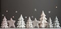 Christmas New Years banner row of ceramic fir trees of pastel colors on grey background. Sparkling star lights Royalty Free Stock Photo
