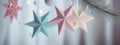 Christmas New Years banner row of ceramic stars hanging by the window. Minimalist Scandinavian decoration of home interior Royalty Free Stock Photo