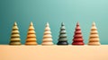 Christmas New Years banner row of wooden multicolored Christmas trees on pink background. Minimalist decoration of home interior Royalty Free Stock Photo