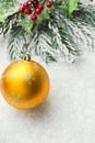 Christmas New Years greeting card winter forest golden yellow glittering ornament ball holly berry fir tree branches in snow