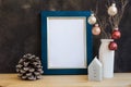 Christmas, New Yera blue and golden frame mockup with blank space for text, artwork, colorful baubles, house candle, pine cones, m