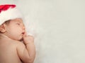 Christmas newborn baby in Santa hat sleeping on white background at home Royalty Free Stock Photo