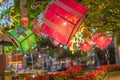 Christmas night fair in garden with people and light decorative