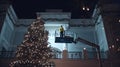 Christmas Night Scene, Worker Arranging Classical Building and Christmas Tree, Festive Preparation Design Material Royalty Free Stock Photo
