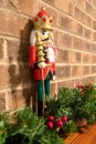 Christmas nutcracker with brick background and decorations with brick fireplace Royalty Free Stock Photo