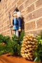 Christmas nutcracker with brick background and decorations with brick fireplace Royalty Free Stock Photo