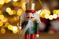 Christmas nutcracker wooden figure, toy soldier decoration with tree lights bokeh. Royalty Free Stock Photo