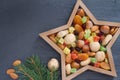 Christmas nuts and dried fruit mix in star-shaped bowl on dark background assortment of delicacies Royalty Free Stock Photo