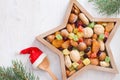 Christmas nuts and dried fruit mix in star-shaped bowl on white background assortment of delicacies Royalty Free Stock Photo