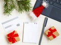 Christmas online shopping flat lay. Notebook and pen. Credit card, Laptop, gifts Royalty Free Stock Photo