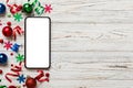 Christmas online shopping from home phone with blank white display top view. smart mobile with copy space on colored