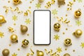 Christmas online shopping from home phone with blank white display top view. smart mobile with copy space on colored