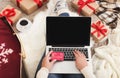 Christmas online shopping. Woman buying presents for xmas on laptop Royalty Free Stock Photo