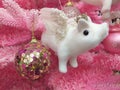 Christmas Ornament. Christmas composition Purple ball with glitter and white pig with crown and silver wings. Christmas tree pink Royalty Free Stock Photo