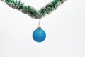 Christmas ornament concept. Ball with glamorous ornaments hang on shimmering green tinsel. Decoration for Christmas tree Royalty Free Stock Photo