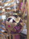 Christmas Ornament. Elegant violet crystal ball with golden flowers. Royalty Free Stock Photo