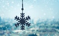 Christmas ornament Snowflake hanging mobile with snowfall on blur outdoor landscape background