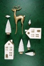 Christmas ornaments backdrop styled with gold reindeer and village houses.