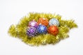 Christmas ornaments balls lay on golden tinsel as eggs in nest. Balls as eggs in nest symbol of beginning. Balls for