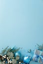 Christmas ornaments and blue winter decor frame a large central copy space on a light blue backgroun Royalty Free Stock Photo