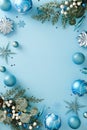 Christmas ornaments and blue winter decor frame a large central copy space on a light blue vertical Royalty Free Stock Photo
