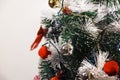Green Christmas tree with red and gold and silver ornaments. Royalty Free Stock Photo