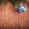 Christmas ornaments and fir tree branch on a rustic wooden background. Xmas card. Happy New Year. Top view Royalty Free Stock Photo