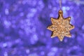 Christmas ornaments golden star on violet bokeh background Royalty Free Stock Photo