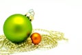 Christmas ornaments - green and orange ball with golden pearls Royalty Free Stock Photo